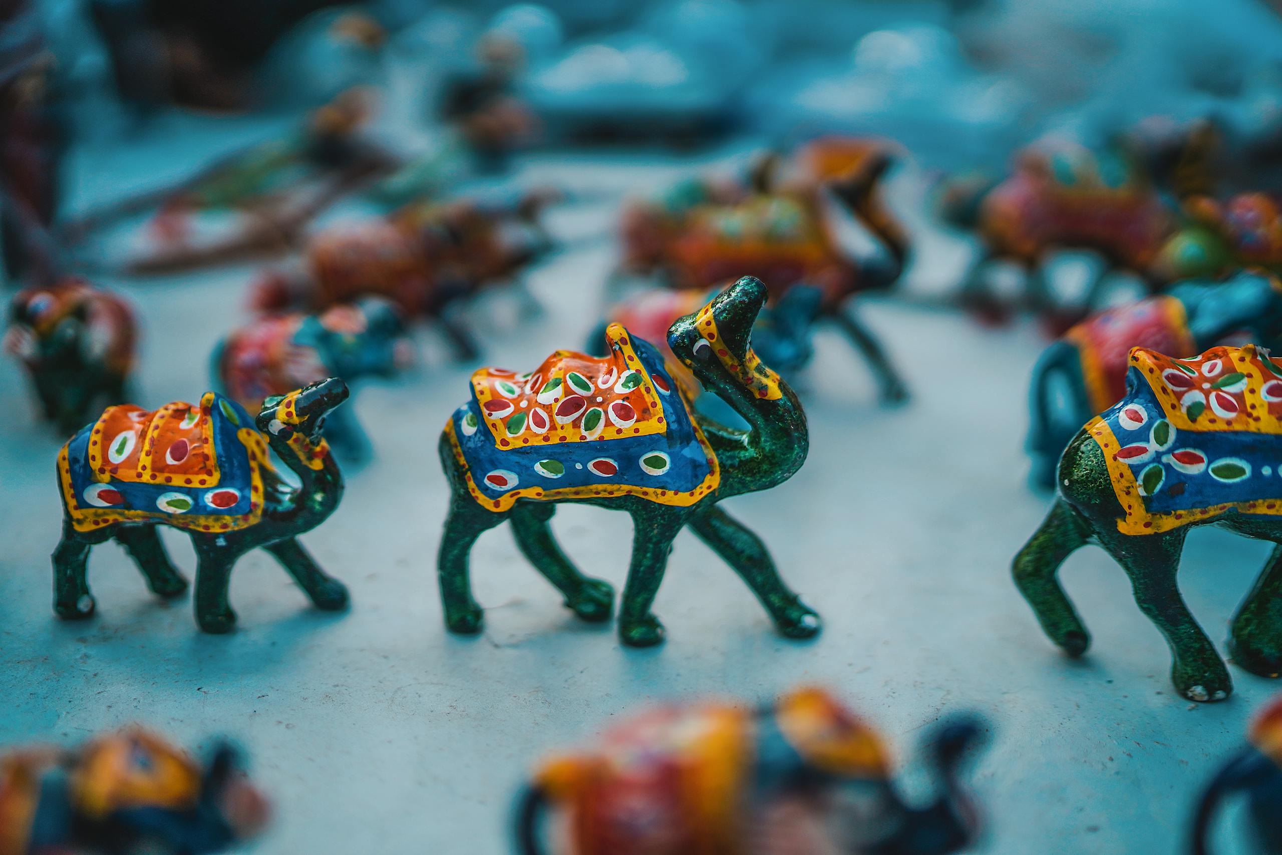 Vibrant camel figurines showcasing traditional Indian art at Jaipur market.